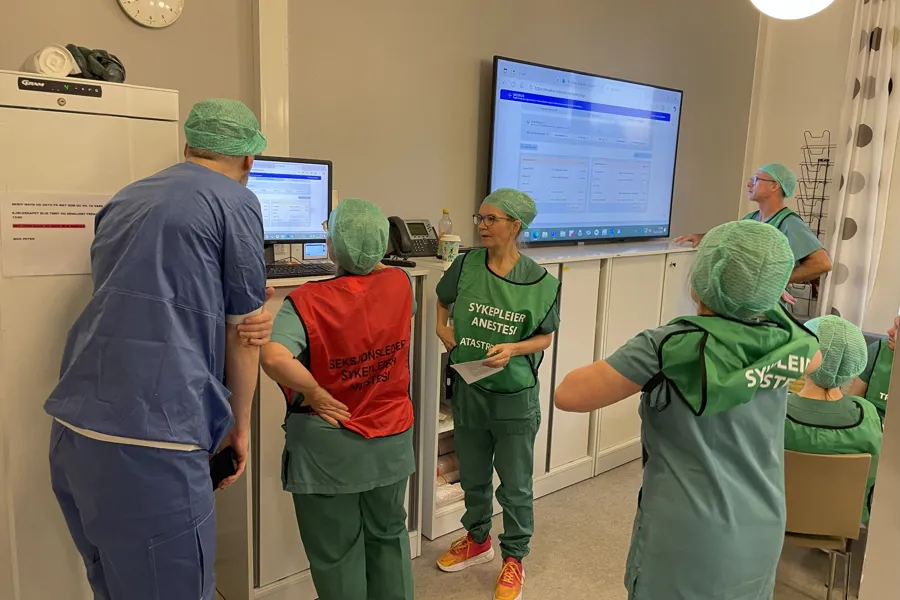 En gruppe mennesker på sykehus som ser på en skjerm under en beredskapsøvelse